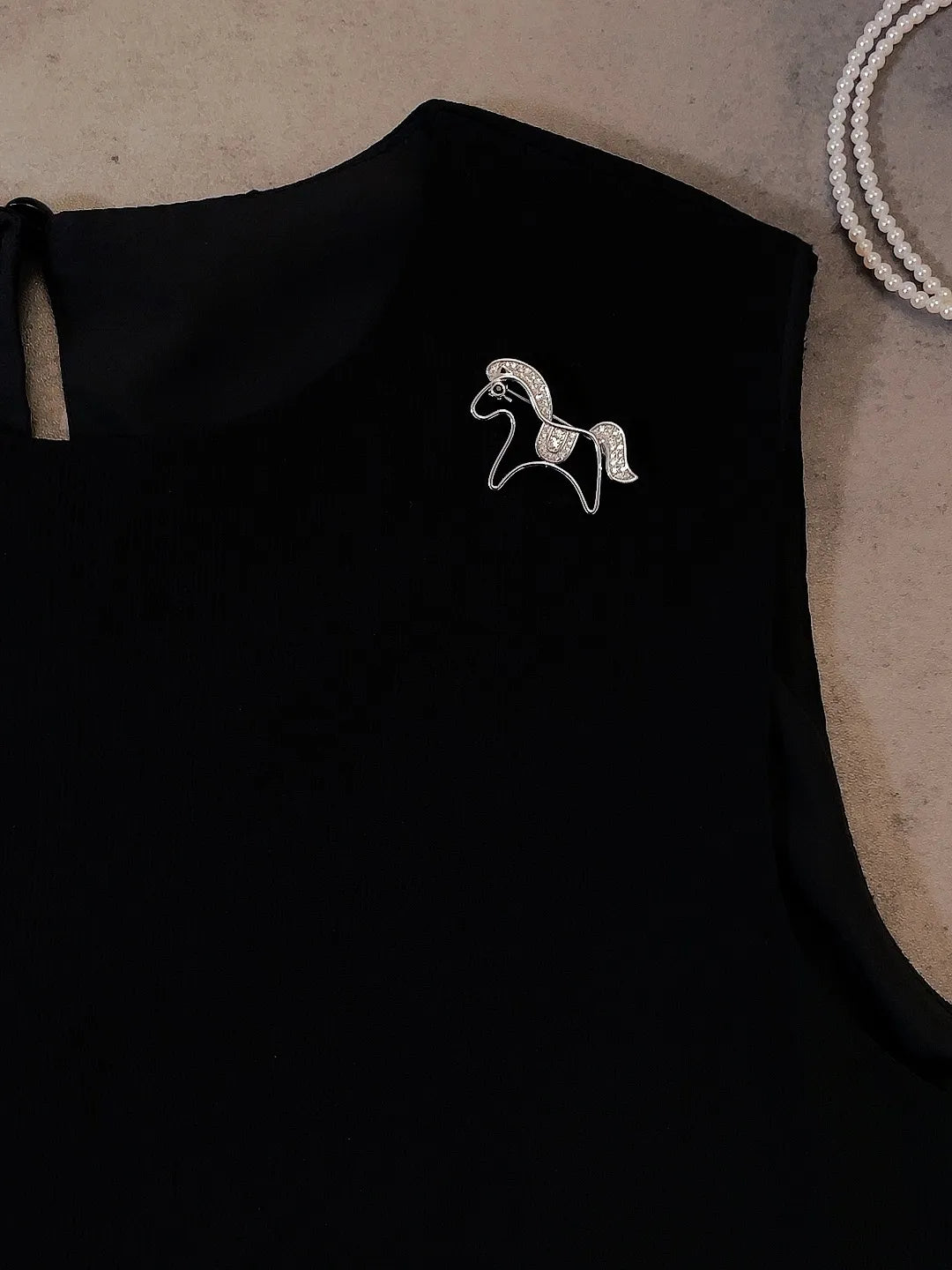 Golden pony brooch detail