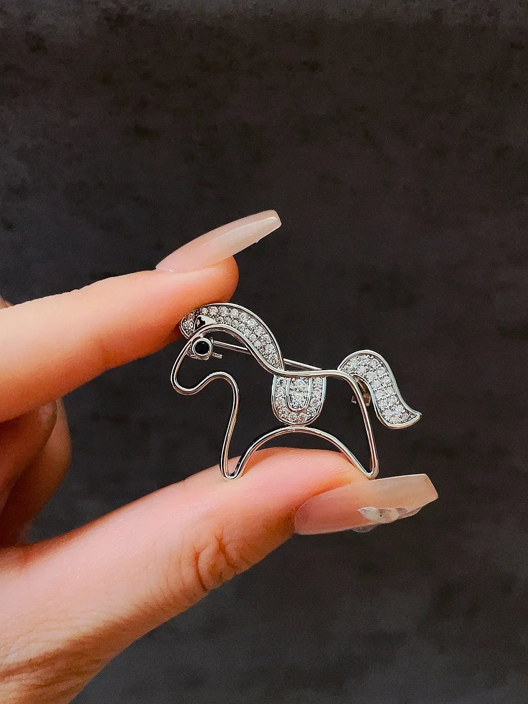 Golden pony brooch styling