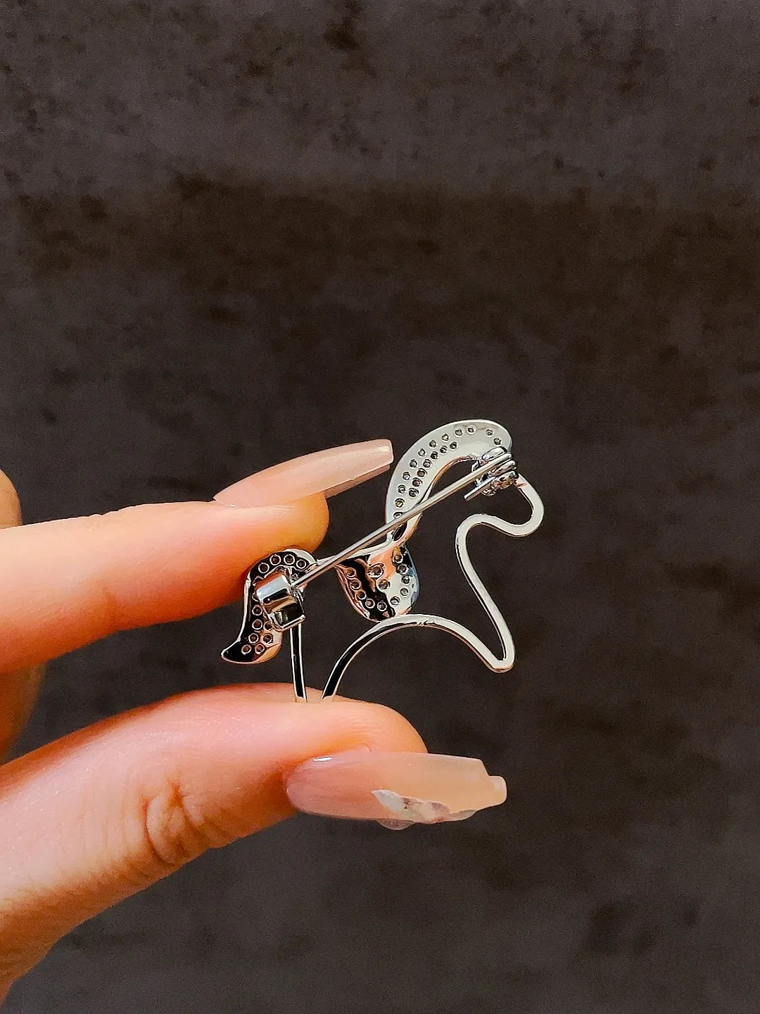 Golden pony brooch close up